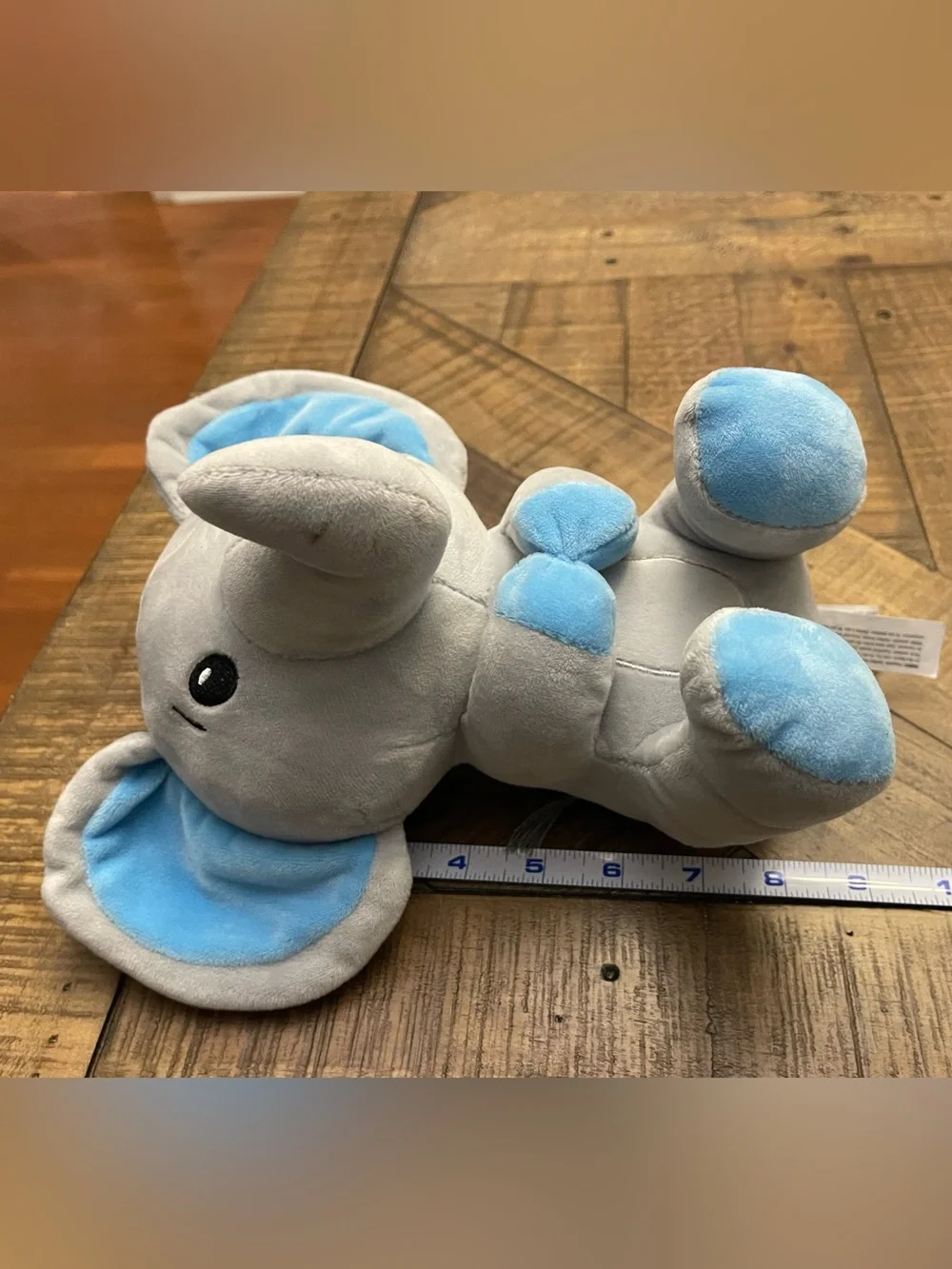 Amscan plush elephant balloon weight featuring blue ears and blue feet
